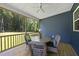 Covered porch featuring a table, chairs, and views of the wooded backyard at 374 Heart Pine Dr, Wendell, NC 27591