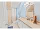 Bathroom with a white vanity, soft blue walls, and a tiled bathtub at 3806 Lochnora Pkwy, Durham, NC 27705