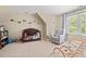 Bright bedroom with natural light, a crib, glider, and playful transportation-themed wall decor at 3806 Lochnora Pkwy, Durham, NC 27705