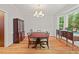 Formal dining room with hardwood floors, elegant chandelier, and sideboard furniture at 3806 Lochnora Pkwy, Durham, NC 27705