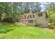 Home exterior highlighting the large backyard with deck and mature trees at 3806 Lochnora Pkwy, Durham, NC 27705