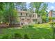 Home exterior highlighting the large backyard with deck and mature trees at 3806 Lochnora Pkwy, Durham, NC 27705