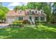 Charming single-Gathering home with lush green lawn, mature landscaping, and dormer windows at 3806 Lochnora Pkwy, Durham, NC 27705