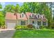 Charming single-Gathering home with lush green lawn, mature landscaping, and dormer windows at 3806 Lochnora Pkwy, Durham, NC 27705