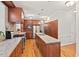 A full view of the Kitchen features stainless steel appliances, granite countertops, and custom wood cabinetry at 3806 Lochnora Pkwy, Durham, NC 27705