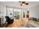 Spacious living room leading to a dining area and kitchen, featuring wood floors and lots of natural light at 3806 Lochnora Pkwy, Durham, NC 27705
