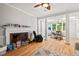 Bright living room with a fireplace, large columns and wood floors at 3806 Lochnora Pkwy, Durham, NC 27705