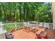 Relaxing outdoor patio with a grill, seating, and lush greenery at 3806 Lochnora Pkwy, Durham, NC 27705