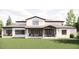 Expansive backyard featuring two covered patios, seating, and a well-manicured lawn at 4 Rainforest Pl, Apex, NC 27523