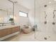 Modern bathroom featuring double vanity, standalone tub, and glass enclosed shower at 4 Rainforest Pl, Apex, NC 27523