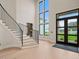 Bright foyer with soaring ceilings, a grand staircase, and an abundance of natural light at 4 Rainforest Pl, Apex, NC 27523