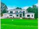 Stunning modern home boasts a manicured lawn, stone accents, and a grand entrance, creating instant curb appeal at 4 Rainforest Pl, Apex, NC 27523