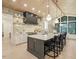 The kitchen features a large island, stone accent wall, modern appliances, and stylish pendant lighting at 4 Rainforest Pl, Apex, NC 27523