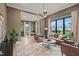 Spacious living room with large windows, hardwood floors, and a separate office area at 4 Rainforest Pl, Apex, NC 27523
