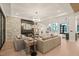 Open-concept living room with fireplace, modern lighting, and views to the foyer at 4 Rainforest Pl, Apex, NC 27523