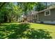 Well-maintained home exterior featuring a spacious backyard with lush green lawn and covered patio at 4001 Pin Oak Rd, Raleigh, NC 27604