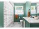 Modern bathroom with green walls, marble floors, and a shower-tub combination at 4001 Pin Oak Rd, Raleigh, NC 27604