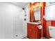 Vibrant bathroom boasts a walk-in shower with glass enclosure, modern vanity, and bright color scheme at 4001 Pin Oak Rd, Raleigh, NC 27604
