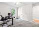 Bright bedroom with a ceiling fan, window, and desk with a computer setup at 4001 Pin Oak Rd, Raleigh, NC 27604