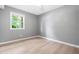 Bedroom featuring a window, ceiling fan, gray walls, and wood-style floors at 4001 Pin Oak Rd, Raleigh, NC 27604