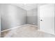The gray bedroom has neutral carpet, one window, and a white door at 4001 Pin Oak Rd, Raleigh, NC 27604