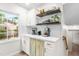 Charming butler's pantry with white cabinetry, open shelving, subway tile backsplash, and marble countertops at 4001 Pin Oak Rd, Raleigh, NC 27604