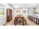 Cozy dining area with a wooden table set, bench seating, and a window offering plenty of natural light at 4001 Pin Oak Rd, Raleigh, NC 27604