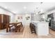 Open eat-in kitchen with an island, stainless appliances, adjacent breakfast area with a table and bench seating at 4001 Pin Oak Rd, Raleigh, NC 27604