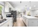 Well-appointed kitchen featuring stainless steel appliances, an expansive island, and an open layout to the dining area at 4001 Pin Oak Rd, Raleigh, NC 27604