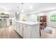 Spacious, updated kitchen with a large center island, modern appliances, and easy access to the dining area at 4001 Pin Oak Rd, Raleigh, NC 27604
