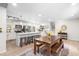 Open kitchen design with a large island, stainless steel appliances, and a view into the adjacent dining and living areas at 4001 Pin Oak Rd, Raleigh, NC 27604