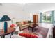 Comfortable living room features neutral furniture, hardwood floors, and a large rug at 4001 Pin Oak Rd, Raleigh, NC 27604