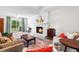 Inviting living room features wood-burning fireplace, light hardwood floors, and access to the backyard at 4001 Pin Oak Rd, Raleigh, NC 27604