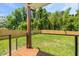 Expansive backyard with green grass, a wood fence, and a deck with black metal railings at 411 Bon Air Ave, Durham, NC 27704