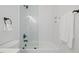 White tiled shower and tub in a bathroom with a glass door and chrome fixtures at 411 Bon Air Ave, Durham, NC 27704