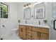 Bathroom featuring dual sinks, quartz countertops, and modern fixtures at 411 Bon Air Ave, Durham, NC 27704