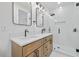 Bathroom with double vanity, modern mirrors, and a sleek glass shower at 411 Bon Air Ave, Durham, NC 27704
