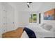 Bedroom featuring a ceiling fan, hardwood floors, and large windows for plenty of natural light at 411 Bon Air Ave, Durham, NC 27704