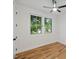 Bedroom with hardwood floors, a ceiling fan, and large windows for plenty of natural light at 411 Bon Air Ave, Durham, NC 27704