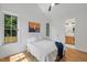 Cozy bedroom with a ceiling fan, hardwood floors, and views to an ensuite bathroom at 411 Bon Air Ave, Durham, NC 27704