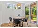 Cozy dining area with a wooden table, modern chairs, and natural light from a sliding glass door at 411 Bon Air Ave, Durham, NC 27704