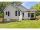 Exterior of a white home with black trim, a lawn, and a covered back porch at 411 Bon Air Ave, Durham, NC 27704