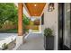 Wide covered porch with wood columns, tongue and groove ceiling, and views of the landscaped front yard at 411 Bon Air Ave, Durham, NC 27704