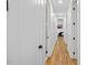 Bright hallway with hardwood floors leading to a bedroom and bathroom, offering a cohesive and modern design at 411 Bon Air Ave, Durham, NC 27704