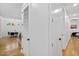 Hallway leading to dining area and bedroom, highlighting hardwood floors and modern interior doors at 411 Bon Air Ave, Durham, NC 27704