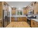 Well-lit kitchen featuring stainless steel appliances, custom cabinetry, and quartz countertops at 411 Bon Air Ave, Durham, NC 27704