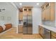 Kitchen showcasing stainless steel refrigerator, custom cabinets, and modern countertops at 411 Bon Air Ave, Durham, NC 27704