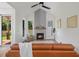 Living room with vaulted ceilings, fireplace with light gray accent wall, hardwood floors, and lots of natural light at 411 Bon Air Ave, Durham, NC 27704