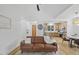 Open floor plan showcasing the living room and kitchen with hardwood floors and lots of light at 411 Bon Air Ave, Durham, NC 27704
