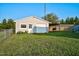 Backyard with a detached garage, featuring a covered area, surrounded by lush green grass at 4536 Massey Rd, Zebulon, NC 27597